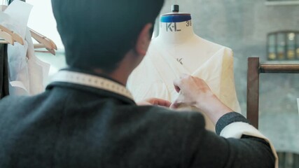 CU Fashion design student dressing and measuring dressmaker's model at University of the Arts / London, England, United Kingdom