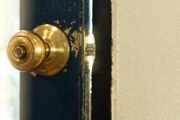 Rustic gold vintage doorknob on antique door.
