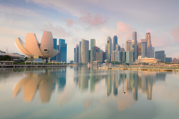 Popular view of Singapore cityscape at early morning with real reflections on sea water