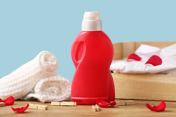 Laundry detergents with clothes, towels and pegs on table