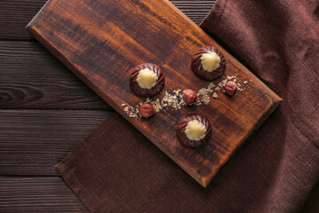 Obraz na płótnie Canvas Tasty chocolate candies with nuts on table