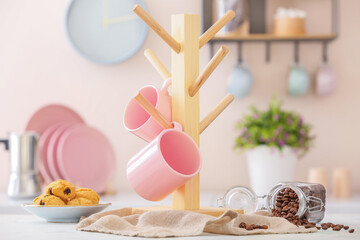 Holder with cups on kitchen table