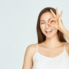 Young beauty girl sign ok. Zero gesture woman smile portrait. Female people hand show approve symbol. Copyspace.