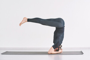 Headstand yoga asana. Man morning exercise at home. Male person isolation sport. Strong sportsman...