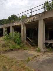 old abandoned cement building with weeds