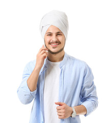 Handsome young Indian man talking by mobile phone on white background