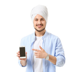 Handsome young Indian man with mobile phone on white background