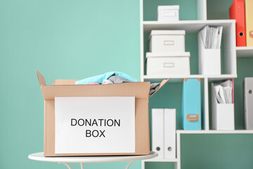 Box with donations on table