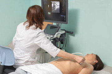 Doctor conducting ultrasound examination of woman in clinic