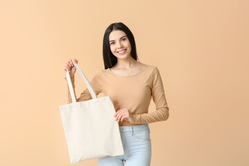 Young woman with eco bag on color background