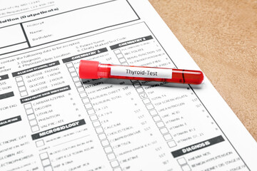 Blood sample in tube and laboratory test form on color background. Concept of thyroid disease