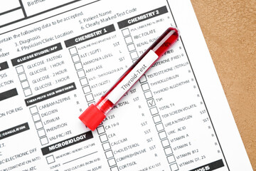 Blood sample in tube and laboratory test form on color background. Concept of thyroid disease