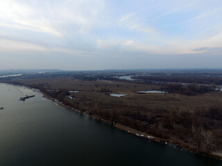 Obraz premium Aerial view of the countryside (drone image).Near river Desna.Winter time.Sunset. Near Kiev,Ukraine
