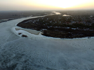 Fototapeta na wymiar Aerial view of the countryside (drone image).Near river Desna.Winter time.Sunset. Near Kiev,Ukraine