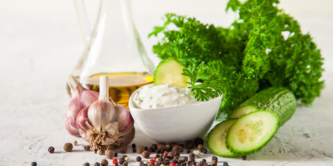 Tzatziki sauce in bowl, with ingredients - cucumber,  dill, lemon, selective focus, copy space