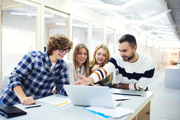 Smiling handsome young international students resting after lesson 