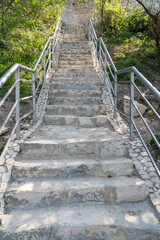A new stone staircase of 800 steps to Jasper Beach, built in the spring of 2020. The reserve on the Black Sea. Cape Fiolent, Crimea Peninsula. Bright sunny spring day, calm crystal clear blue sea. The