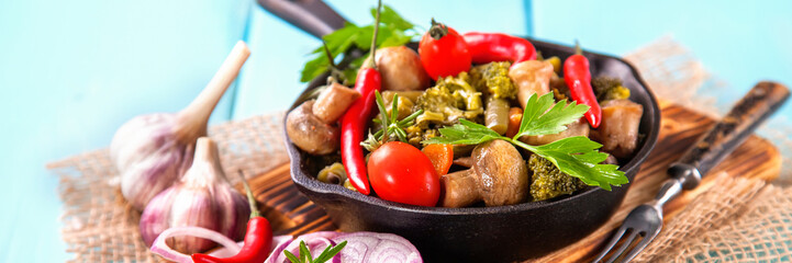stewed mushrooms and vegetables on a frying pan on a table, selective focus, copy space