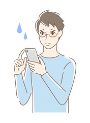 スマホを操作して不安な男性