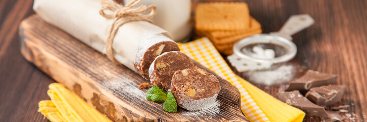 homemade chocolate sausage on a board, selective focus, copy space