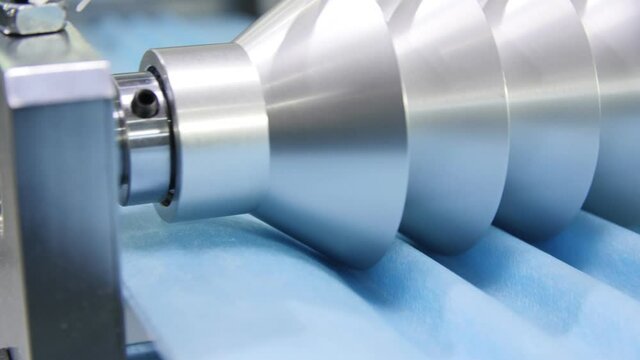 motion past machine making goffers on material for masks