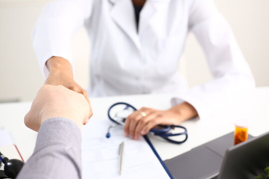Doctor shake hand as hello with patient in office closeup. Welcoming friend introduction or thanks gesture consultation work thankful client talk team trust communication teamwork deal concept