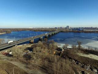Fototapeta na wymiar Moscow Bridge across Dnepr River, photo from drone at winter. Kiev