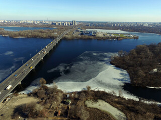 Moscow Bridge across Dnepr River, photo from drone at winter. Kiev