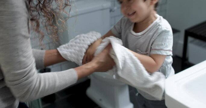 MS Mother and son (2-3) drying hands in bathroom / London, UK