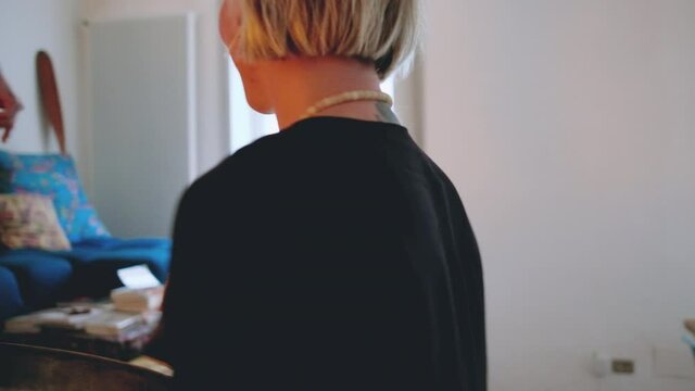 MS Couple relaxing with rin gong in living room / Milan, Italy