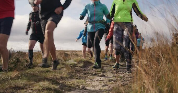 MS Group of people running in landscape / Yorkshire Moors, Yorkshire, UK