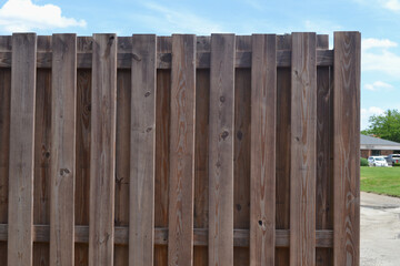 A Closeup View of a Wooden Fence in the Parking Lot