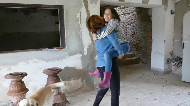 WS MS Happy mother and daughter (10-11) in rundown house / Citta della Pieve, Umbria, Italy