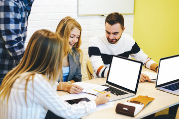 Fototapeta premium Young IT programmers collaborating on creating application using digital computers