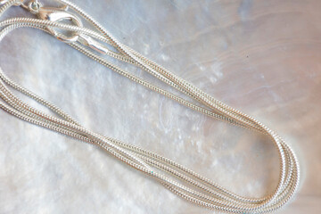 White metal sterling silver chain snake style on white shell background
