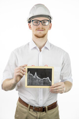 Handsome mining engineer holding tablet with falling graph, looks at camera with smile. Oil refinery industry, market strengthening, reduction in oil production, drilling production concept