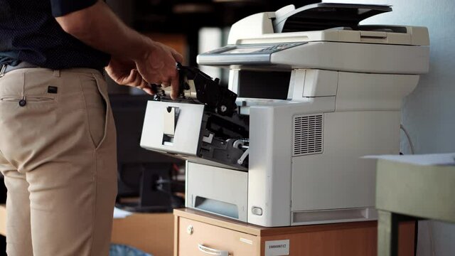 Man Finger Press Buttons On Multifunctional Copier.Man Using Printer Or Scanner In Office.Businessman Printing Document On Workplace.Businessman Working In Office And Preparing Documents For Signature