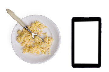 Millet porridge on a white plate with a fork. Isolated on white. The concept of healthy food that diet. vegetarian