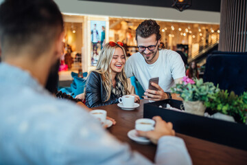 Sharing their online photo at the cafe