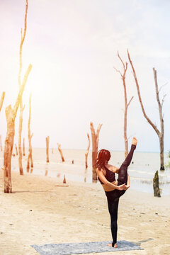 Young woman practicing yoga in the nature, Female happiness, Asian woman is practicing yoga at beach