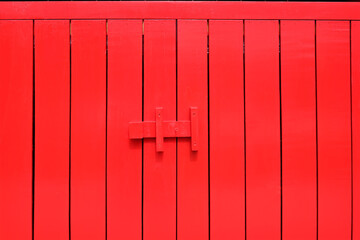 Red wood door with latch colorful texture abstract for background