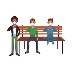 interracial men wearing medical masks using technology seated in park chair