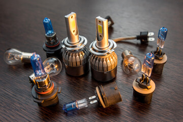 New light  halogen car bulbs on dark background, vehicle headlight spare parts