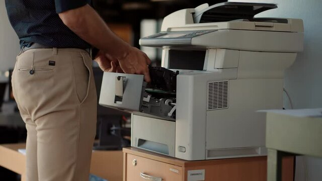 Man Finger Press Buttons On Multifunctional Copier.Man Using Printer Or Scanner In Office.Businessman Printing Document On Workplace.Businessman Working In Office And Preparing Documents For Signature