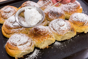 bakery fresh bun dusted powdered sugar. closeup