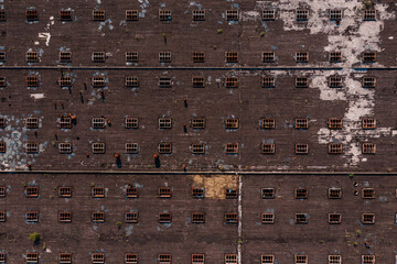 An aerial view of an large industrial factory roof taken with a drone. Abstract striped pattern of windows for backgrounds