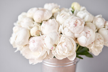 Obraz na płótnie Canvas White Odile peonies in a metal vase. Beautiful peony flower for catalog or online store. Floral shop concept . Beautiful fresh cut bouquet. Flowers delivery. Copy space