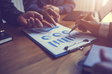 Close up businessman hands pointing to financial data paper, assignment concept.