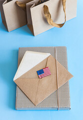 Zero waste concept, kraft brown paper bags and envelope, USA flag on blue white background. 