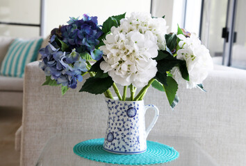 Beautiful white and blue imitation hydragrea flowers in blue and white vase
